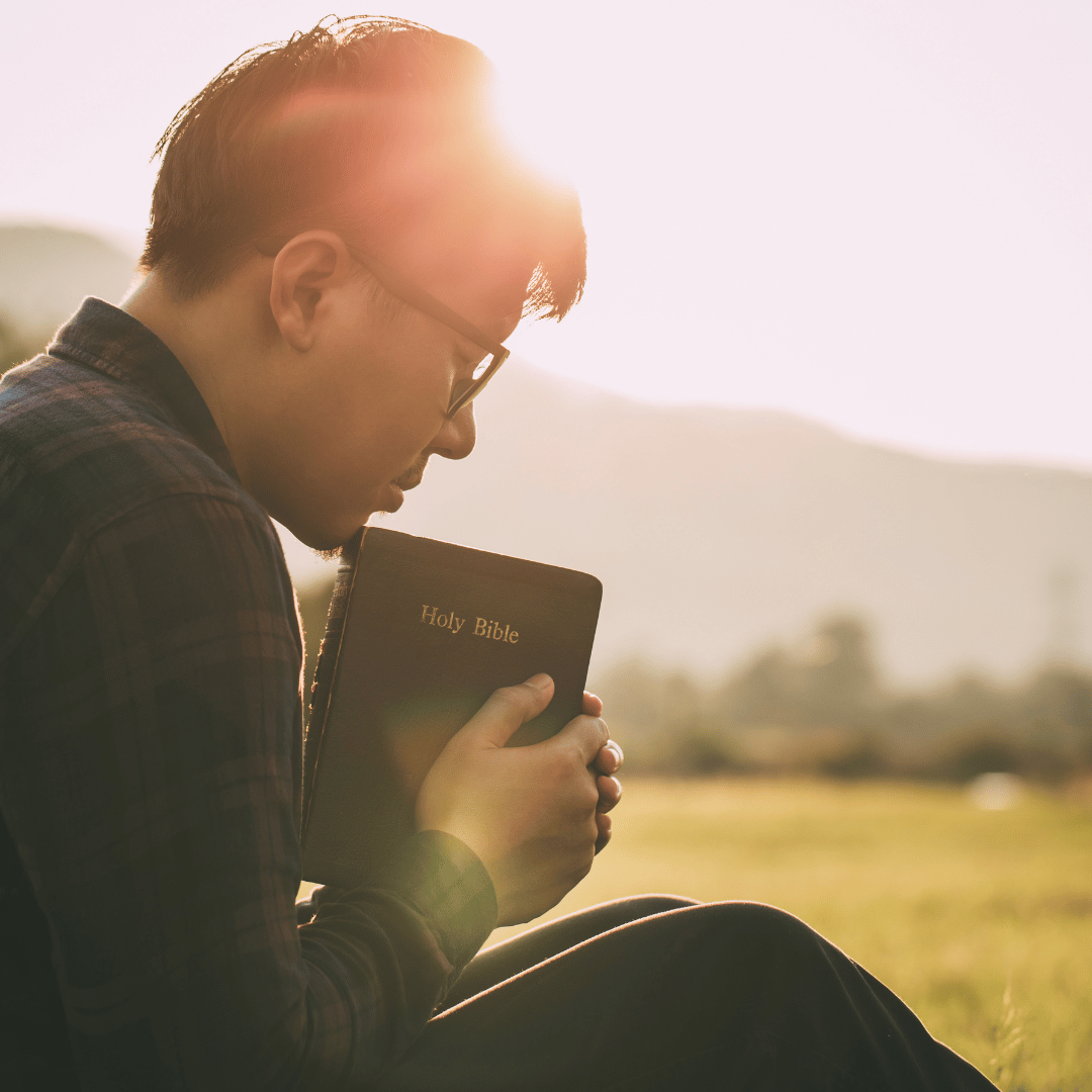 Man praying for guidance with Bible in hand