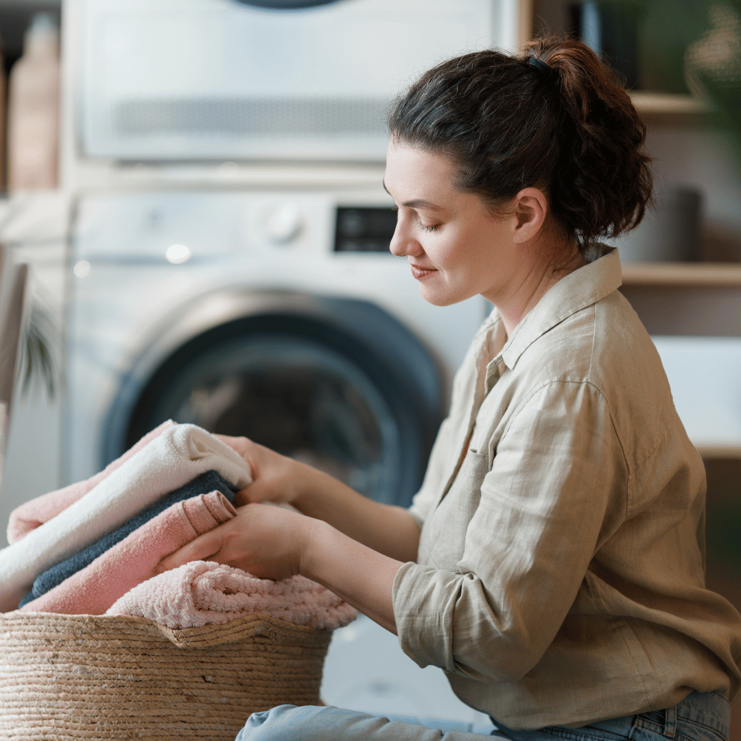 Person folding laundry in soft light