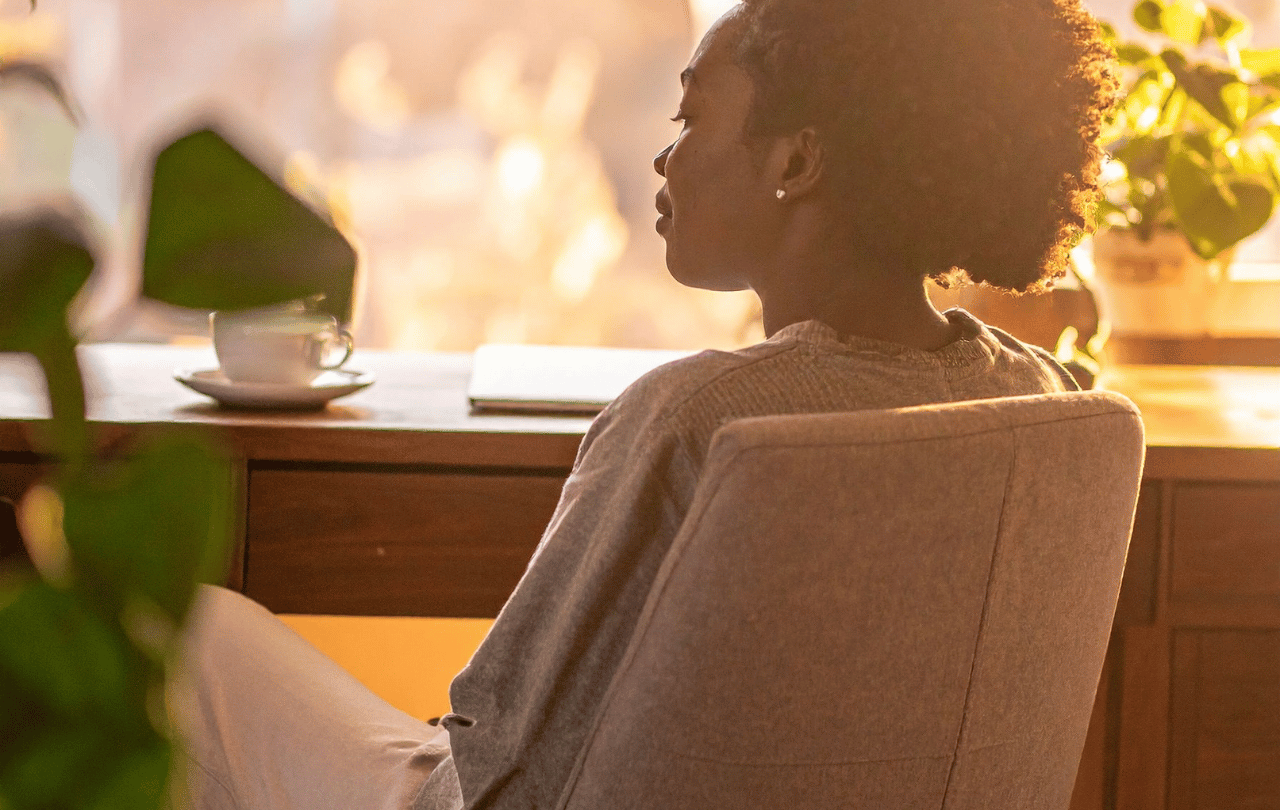 Person gazing out a window as fog clears, representing rediscovering God