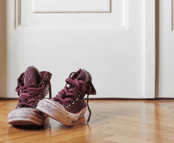 A pair of sneakers by the door, symbolizing meaning found in daily life