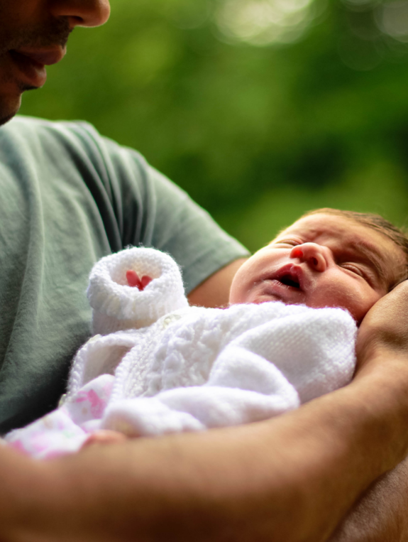 Loving father holding his baby daughter