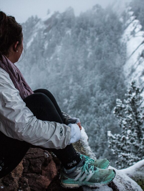 woman looking at snow-capped mountain